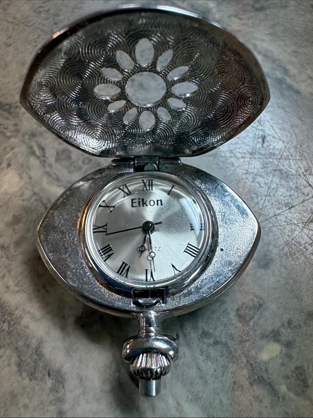 Eikon silver-tone quartz pendant pocket watch with an embossed flip-top lid